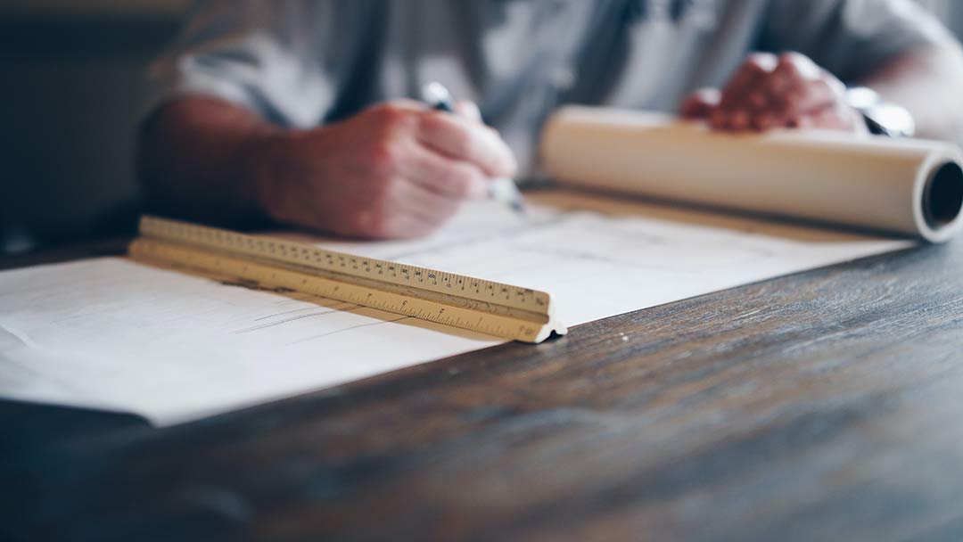 A man preparing a project estimate & design. Photo by Daniel-McCullough