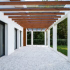 EZ Glaze System Installed over Wooden Beams On Ceiling In Terrace Of Modern White Home