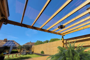 Clear EZ Glaze System installed on Modern Pergola with view of backyard